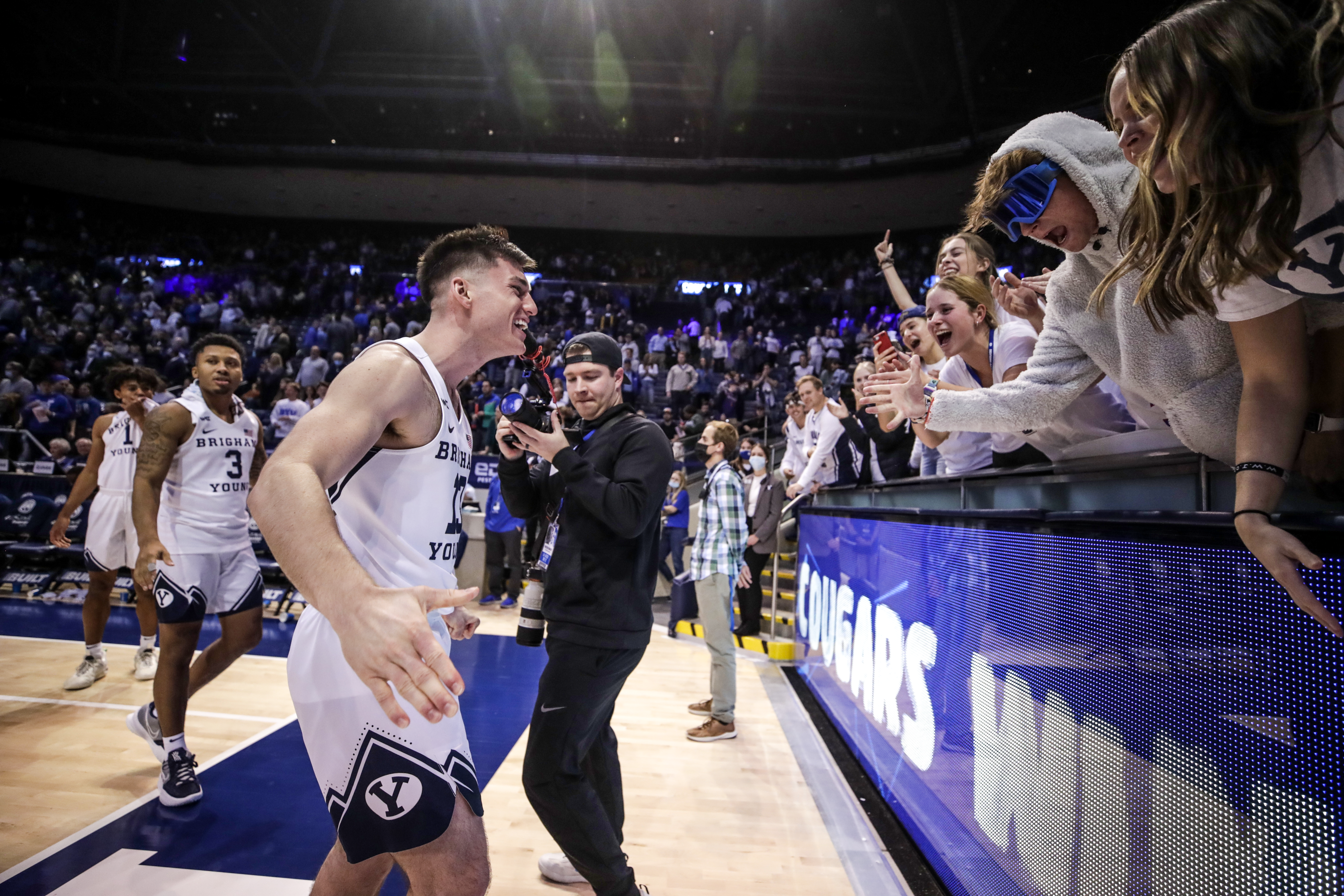 BYU basketball player Alex Barcello celebrates with the crowd after the Cougars 97-61 victory over Central Methodist University.