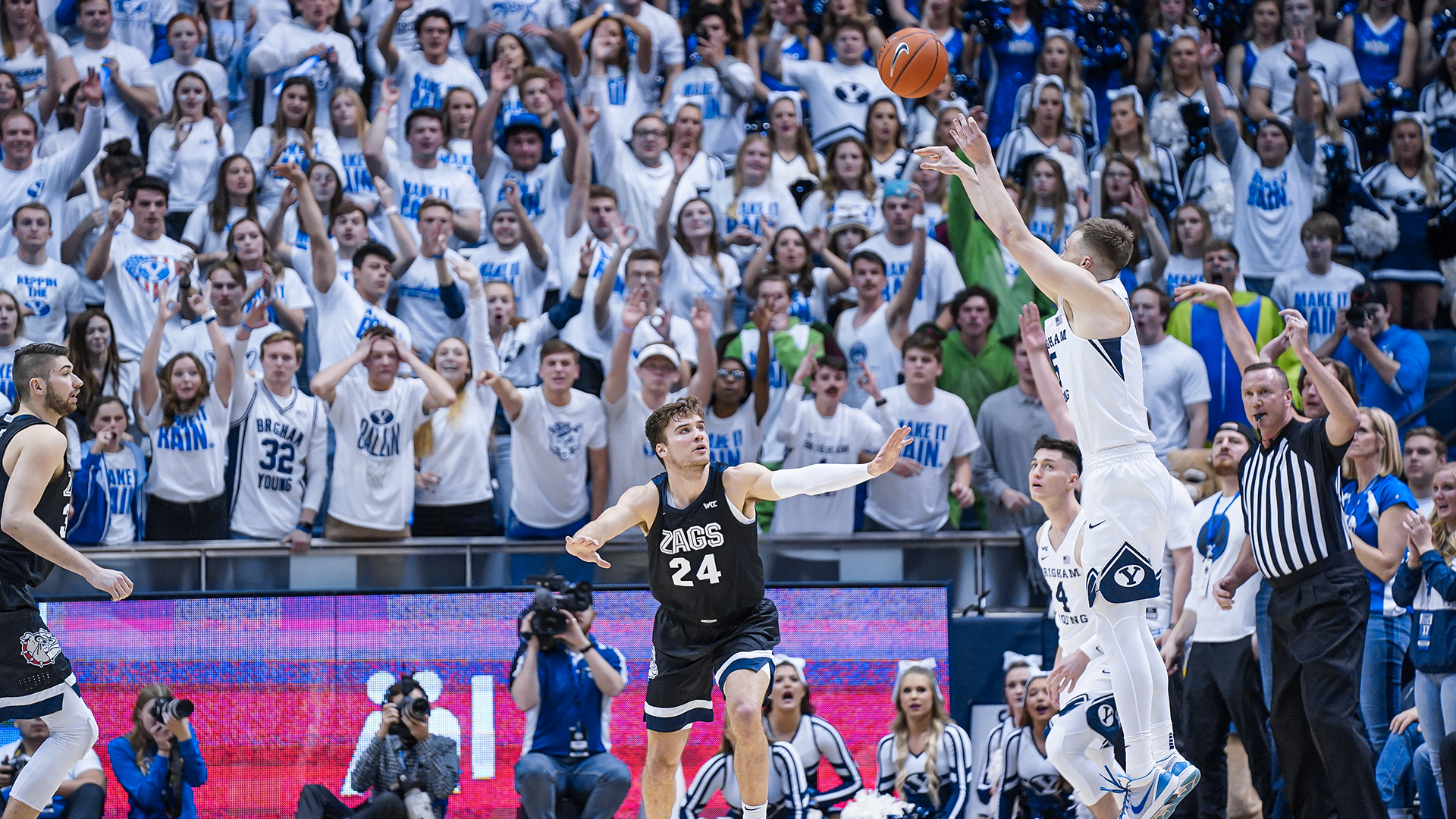 Jake Toolson shoots a 3-pointer from the wing while No. 24 from Gonzaga defends.