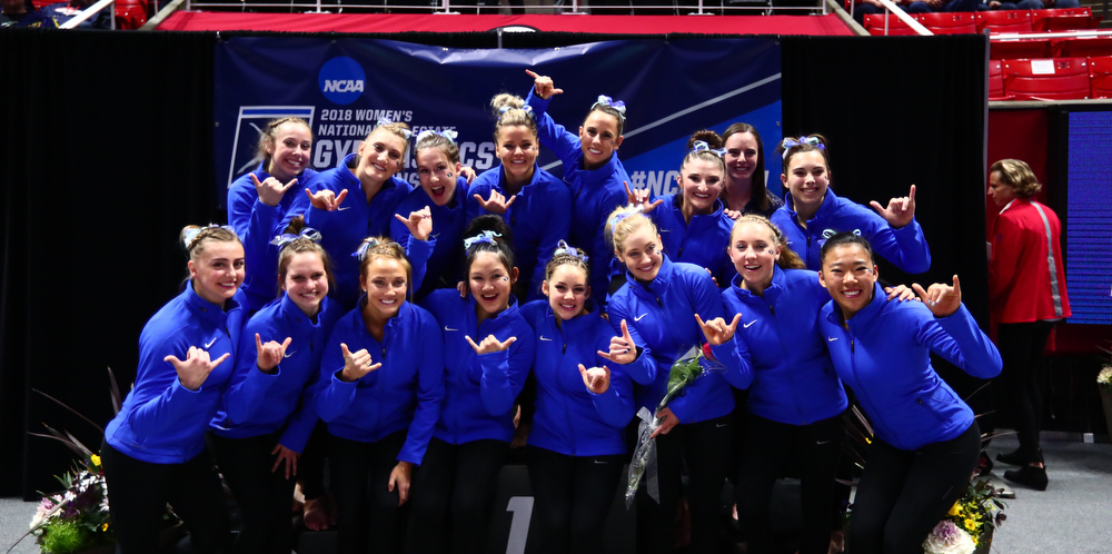 the team poses at the podium at regionals in 2018