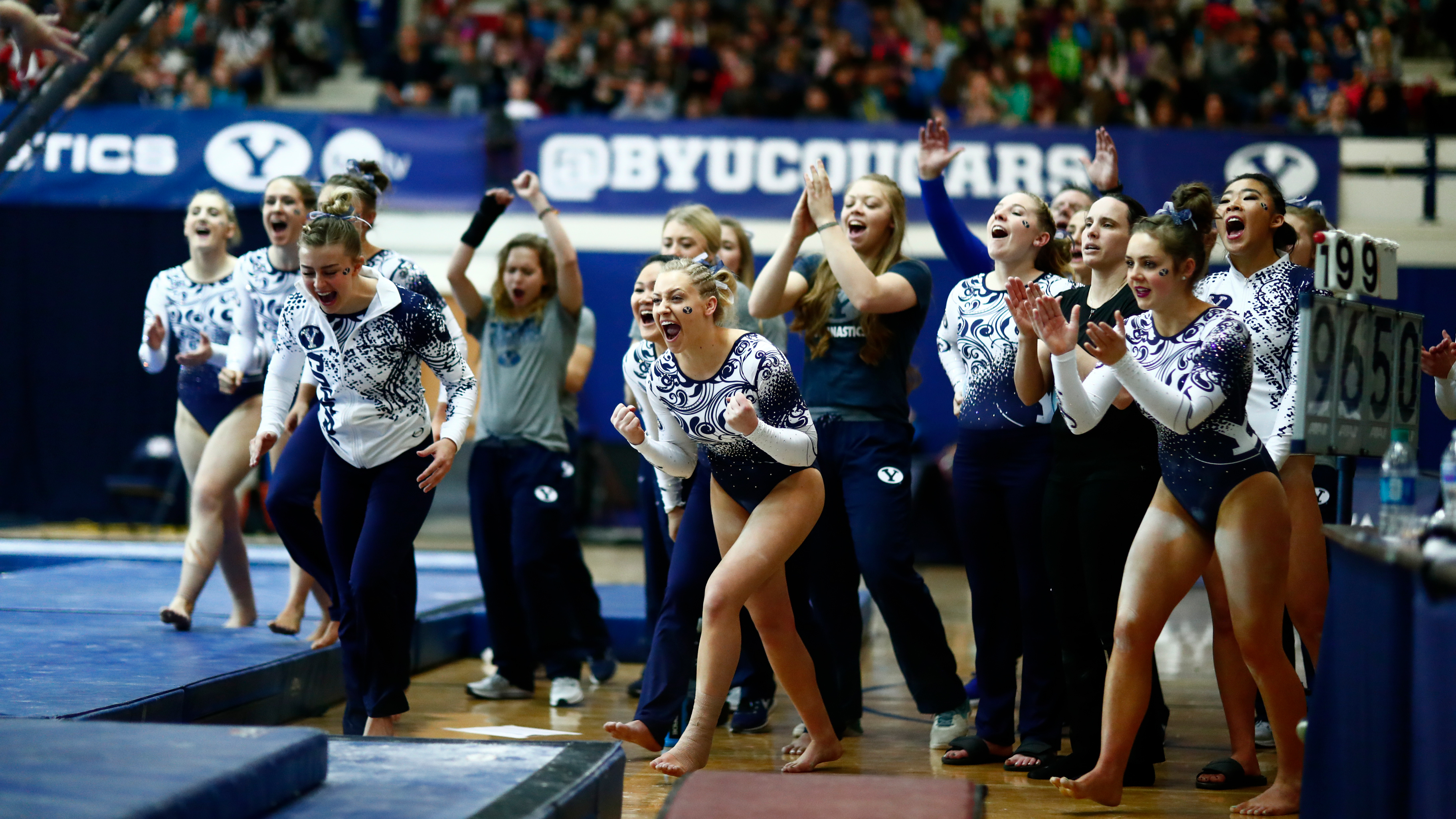 gymnasts cheer after beam routine