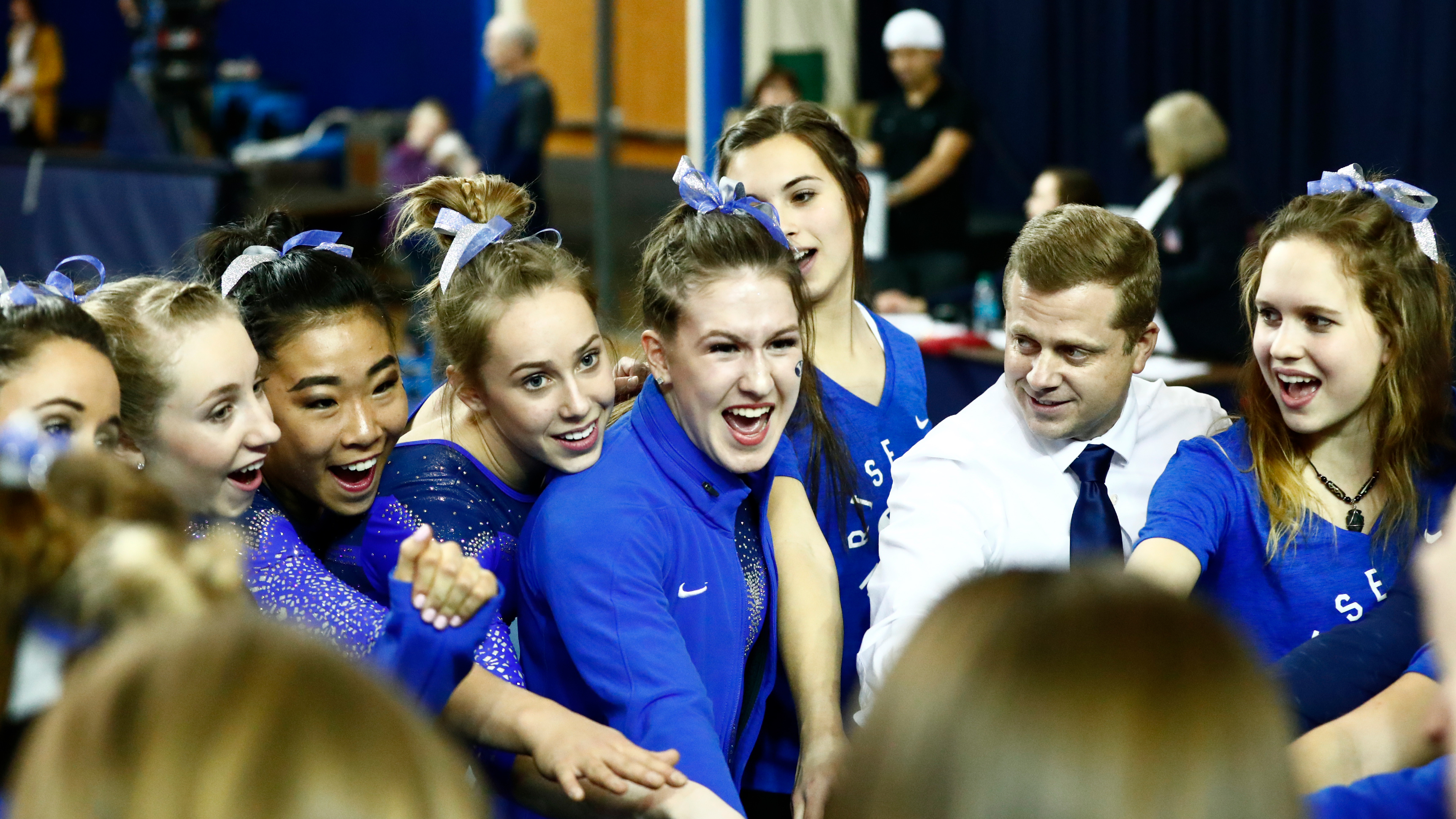 the BYU gymnastics team celebrates after a victory