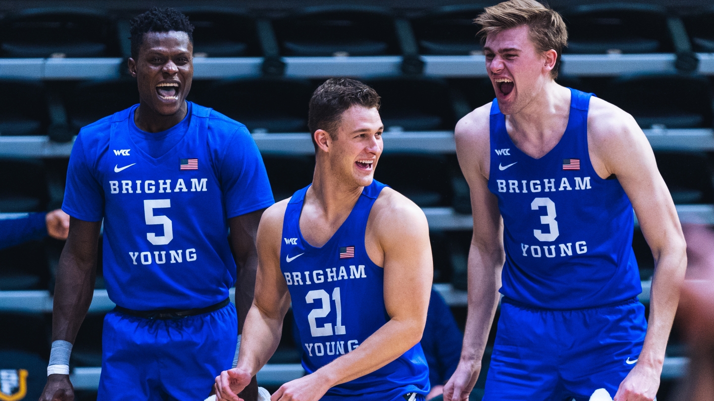 Gideon George, Trevin Knell and Matt Haarms celebrate on the BYU bench