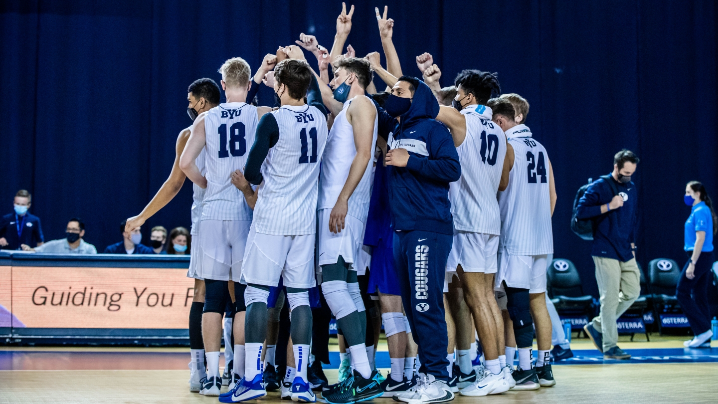 team huddles with arms up 