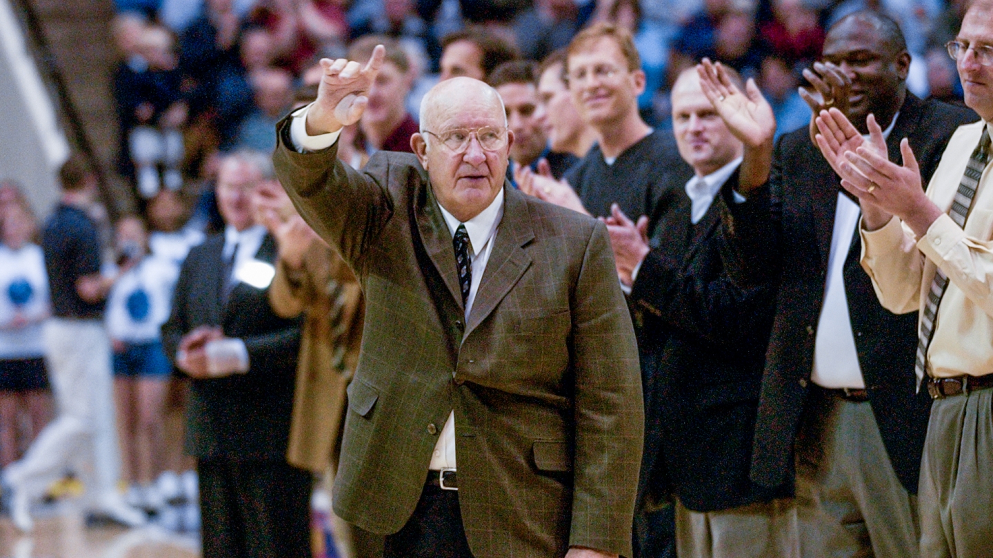 Former BYU coach Ladell Andersen waves to the crowd at halftime of a 2003 BYU men's basketball game.