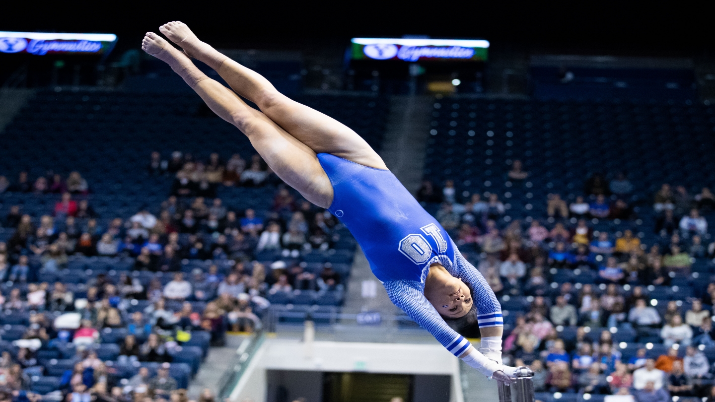 Haley Pitou swings on the uneven bars