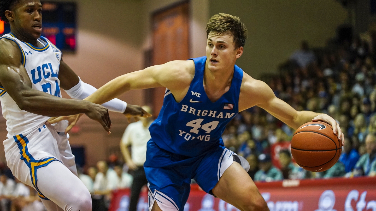 Connor Harding holds off a UCLA defender as he drives to the basket in Maui.