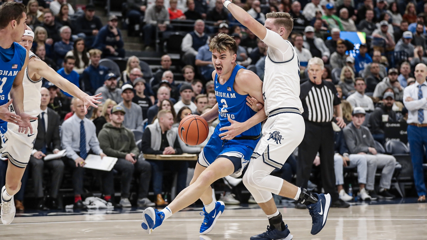 Zac Seljaas drives to the basket against a Utah State defender in Vivint Smart Home Arena.