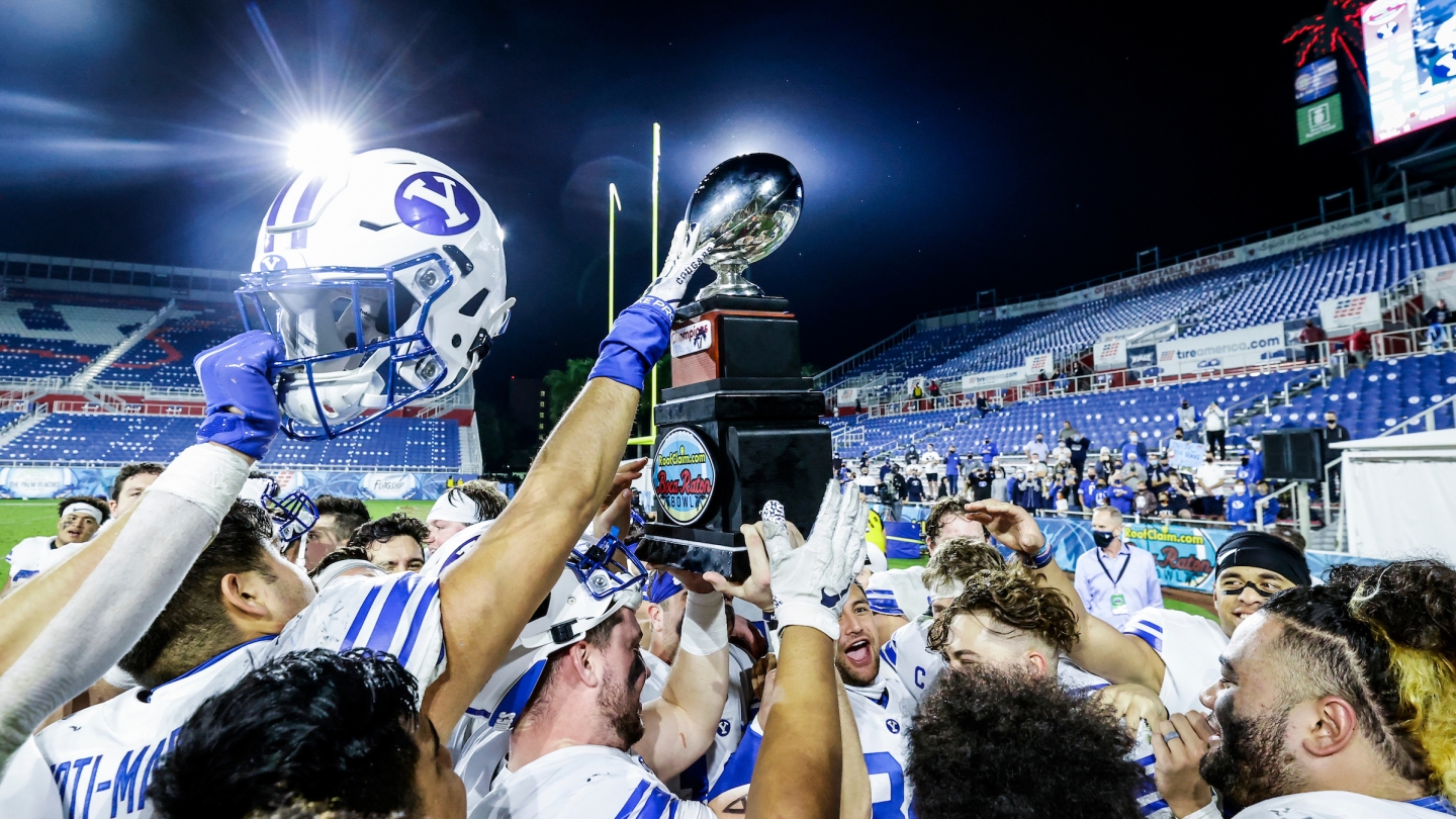 Players hold up the bowl trophy after the win