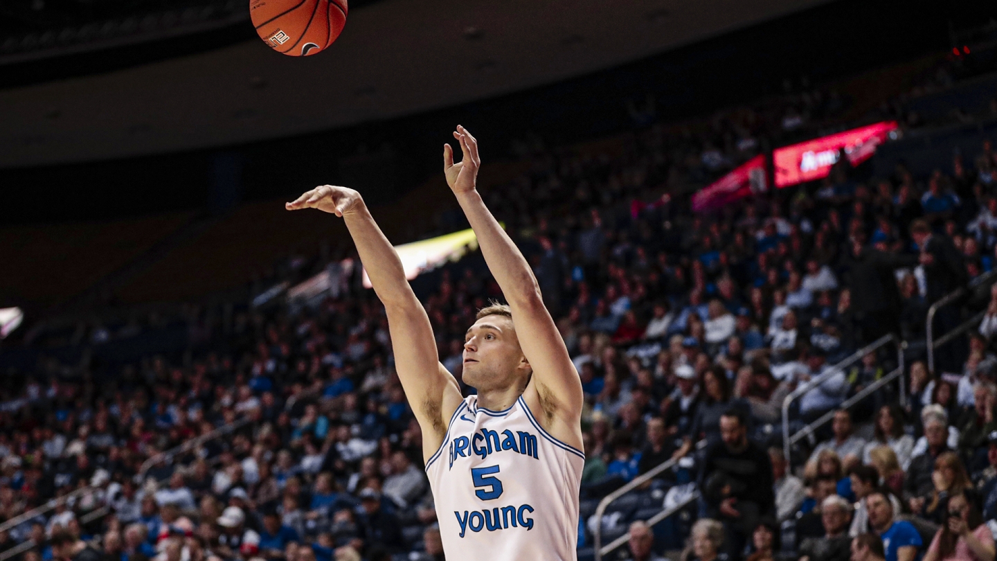 Jake Toolson shoots a 3-pointer against Nevada.