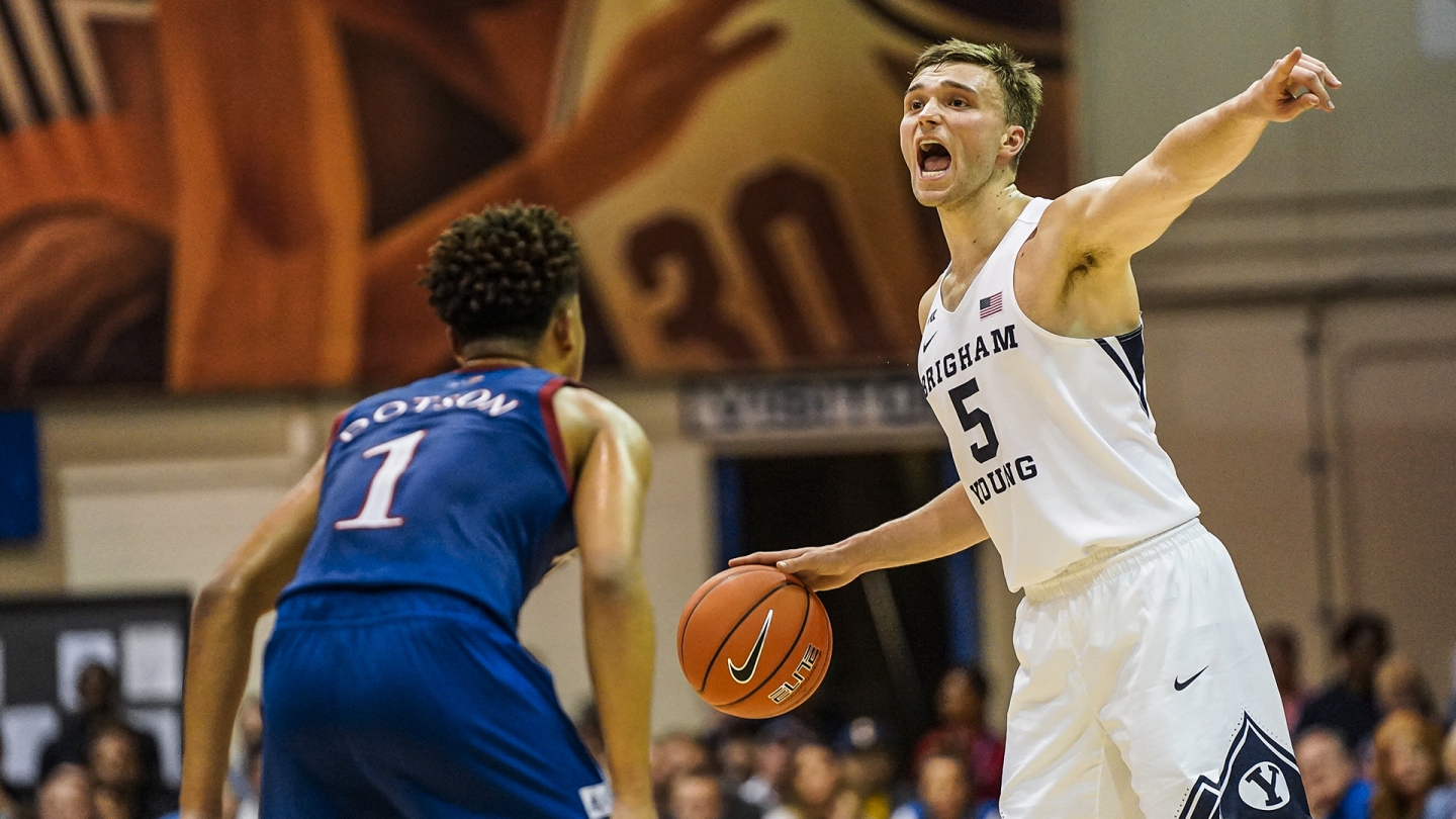 Jake Toolson points with his left hand to direct the BYU offense against Kansas.