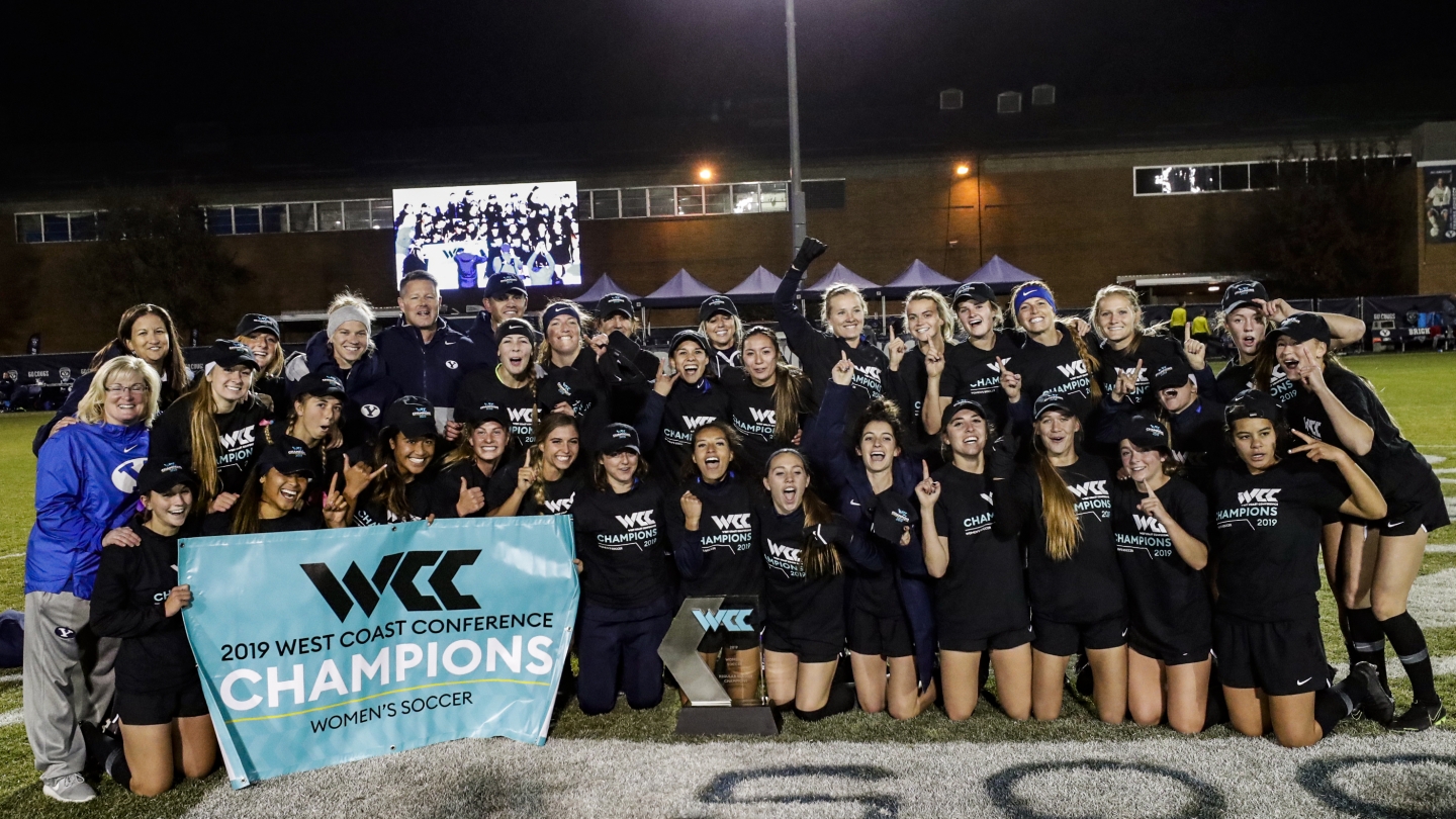 The BYU team posing with the WCC trophy after winning the conference title