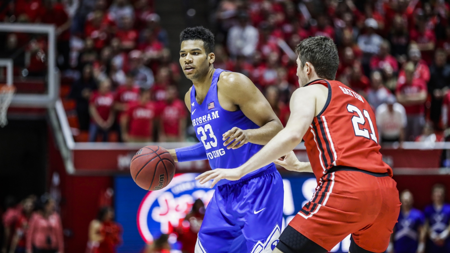 BYU's Yoeli Childs dribbles the ball against a Utah defender.