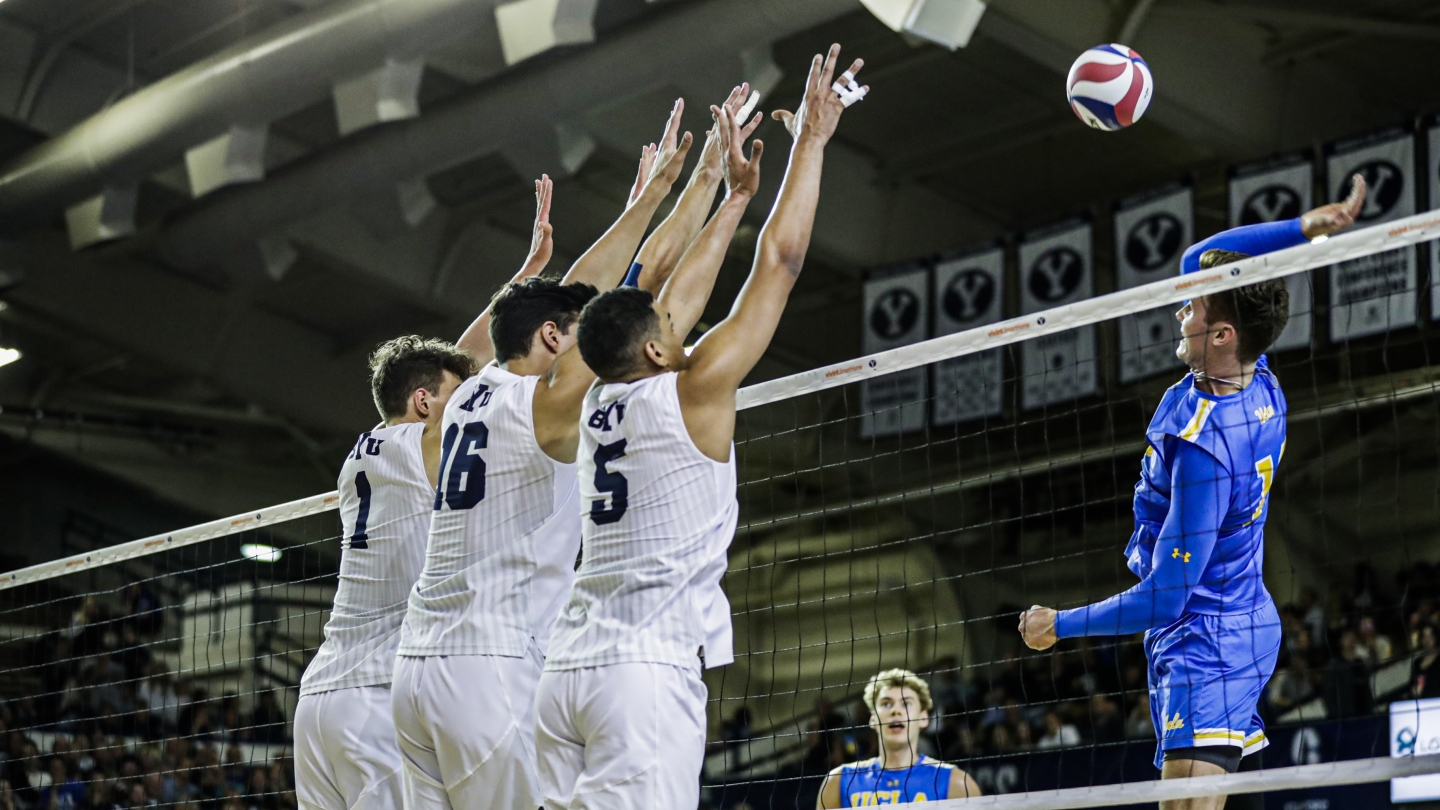 BYU men's volleyball players go up for a block against UCLA