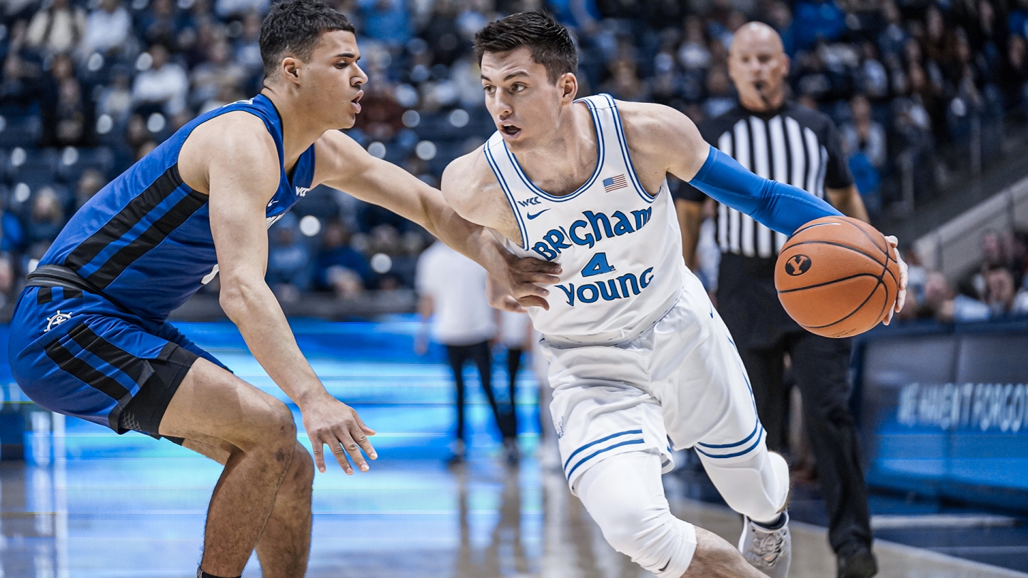 Alex Barcello dribbles with his left hand while a Portland play defends.