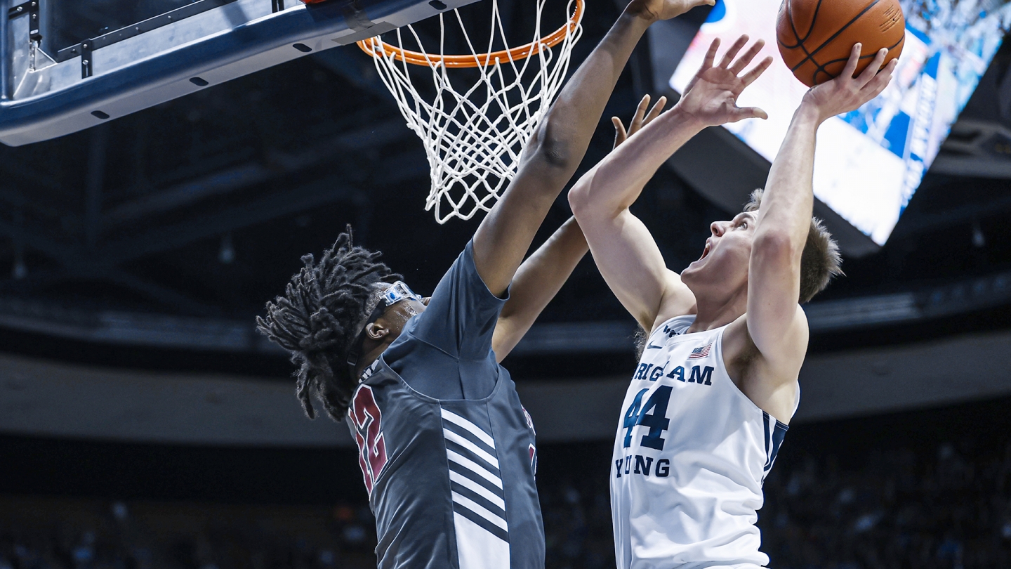 Connor Harding goes up for a left handed layup against a goggles clad Santa Clara defender.