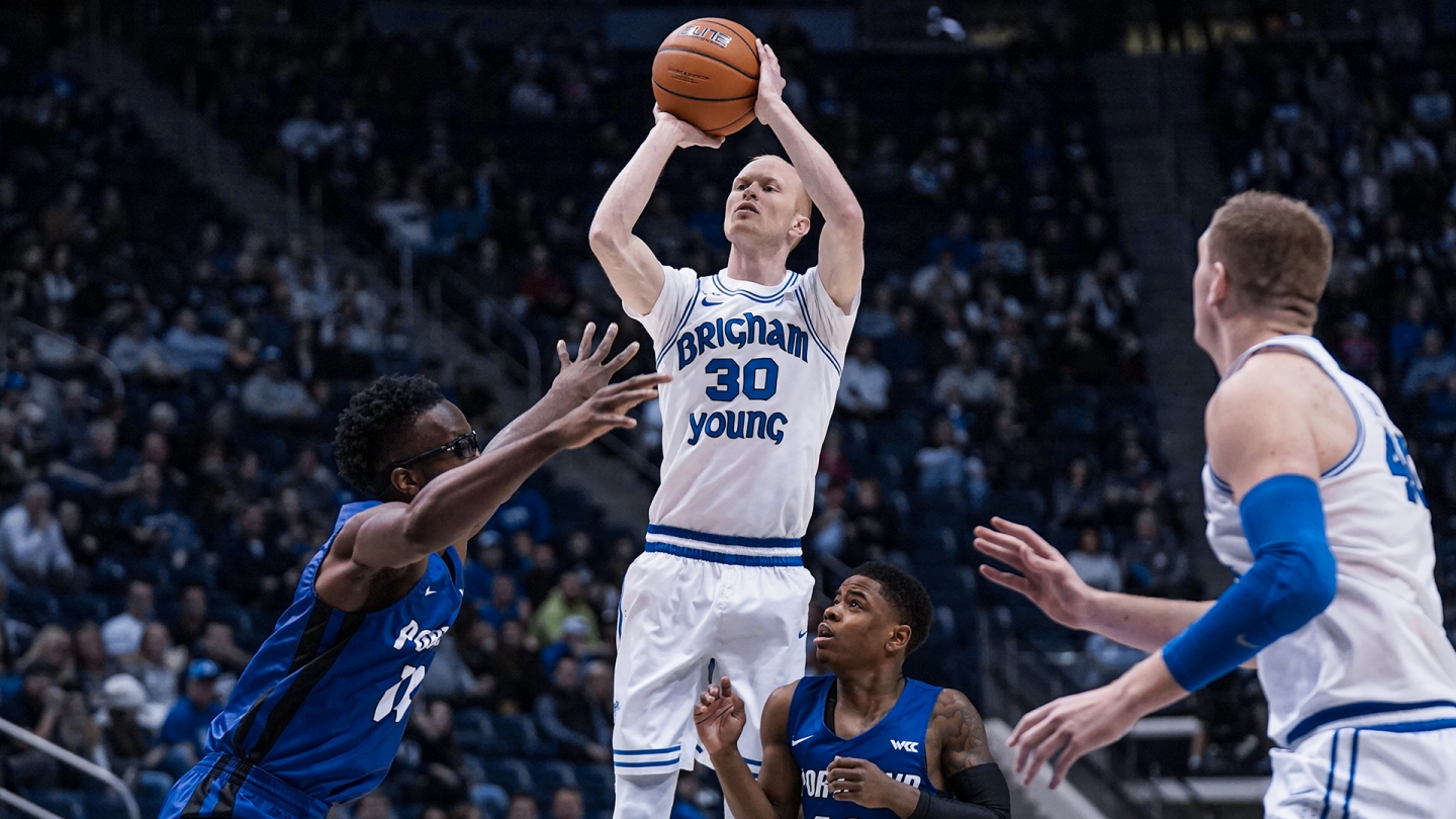 TJ Haws pulls up for a jump shot while Portland defends.