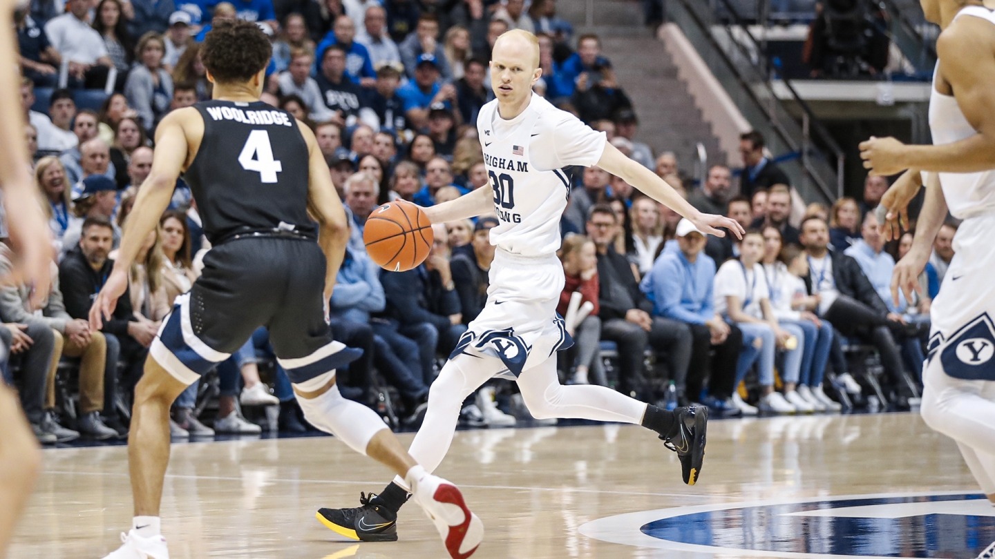 TJ Haws handles the basketball while No. 4 from Gonzaga defends.