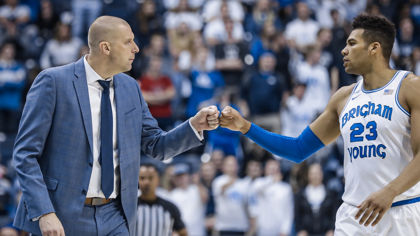 BYU coach Mark Pope and senior forward Yoeli Childs share a fist bump in the Marriott Center.