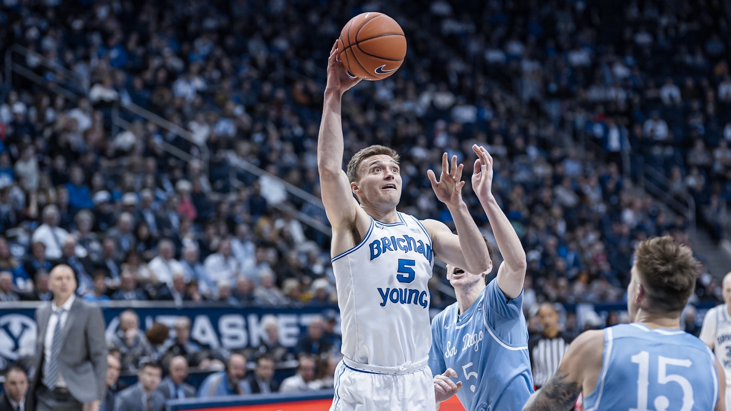 Jake Toolson shoots a layup with the right hand against San Diego.