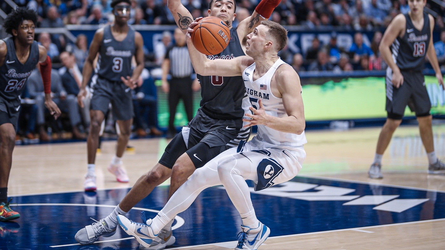 Jake Toolson fakes a shot with the right hand while a Santa Clara player defends.